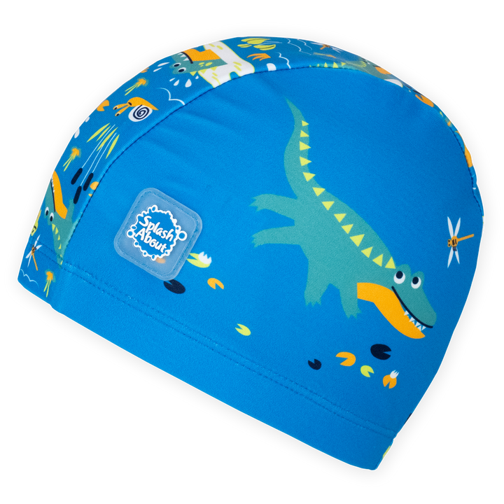 Baby swim hat in blue featuring crocodiles themed print.