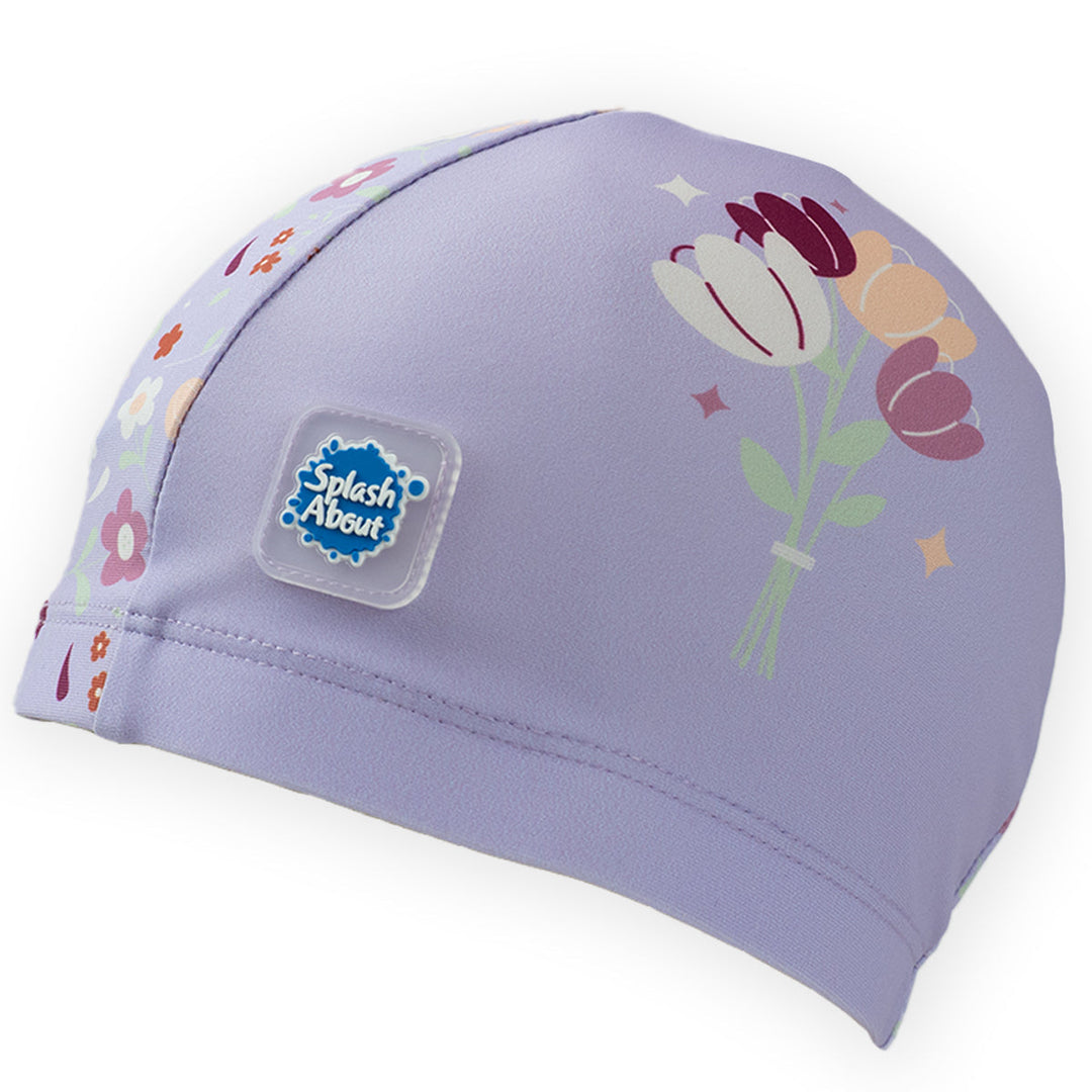 Baby swim hat in lilac featuring floral themed print.