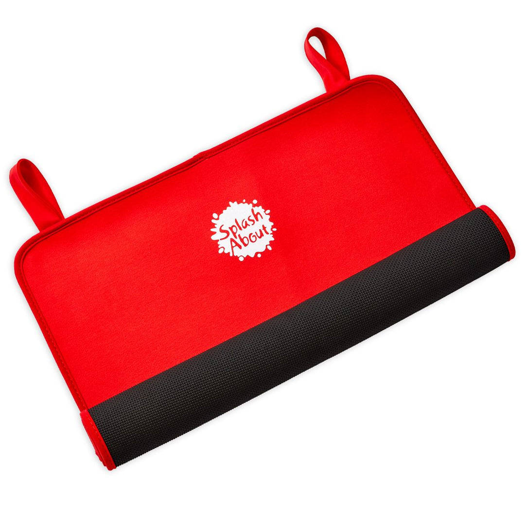 Red neoprene changing mat, half rolled