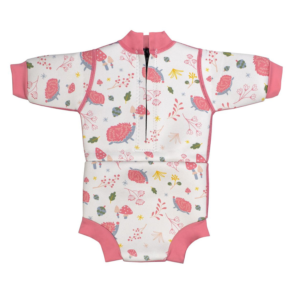 Baby wetsuit with built in swim diaper in white with pink trims and forest themed print, including hedgehogs, mushrooms and leaves. Back.